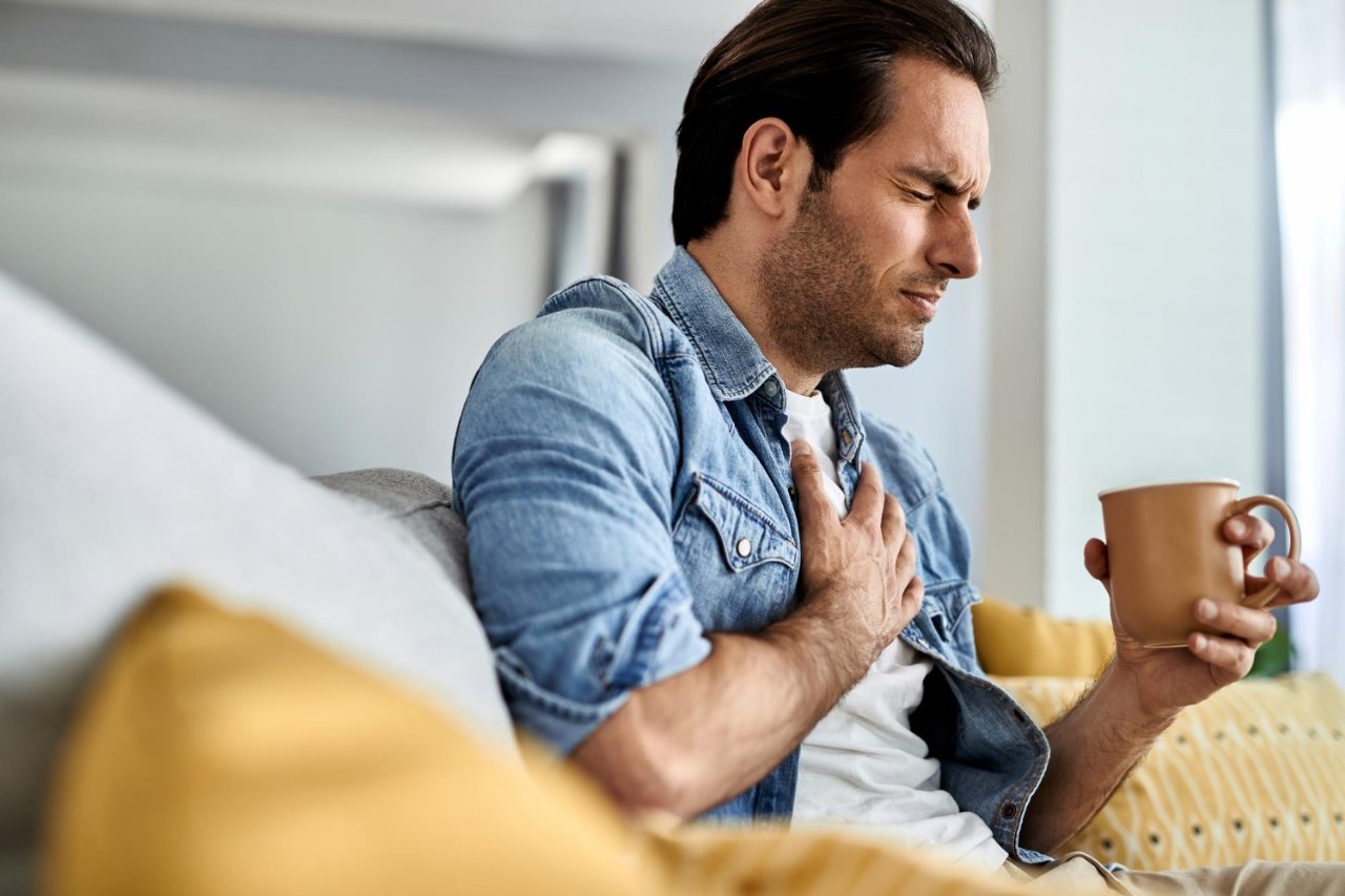 Man looking unwell after drinking coffee